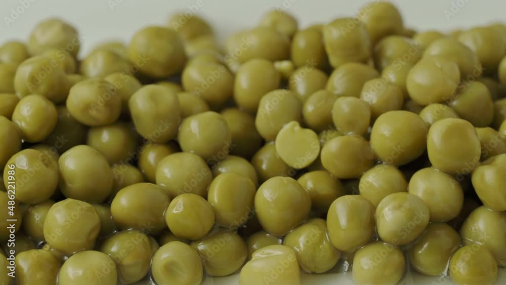 White bowl with canned green peas. Fermented food