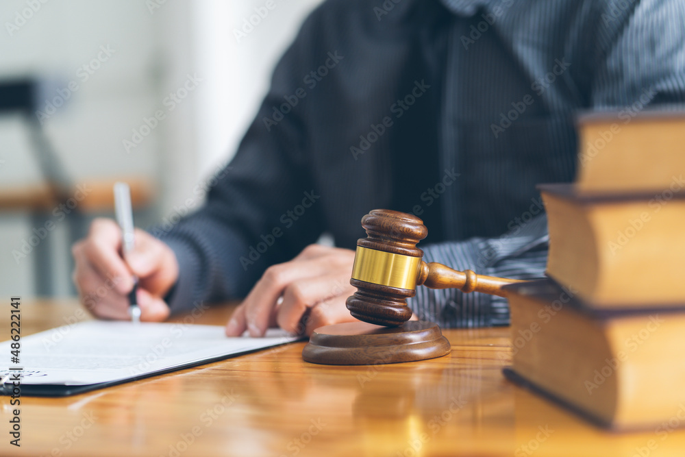 Judge gavel with Justice lawyers, Businessman in suit or lawyer working on a documents. Legal law, advice and justice concept. Judge gavel with Justice lawyers, Businessman in suit or lawyer working on a documents. Legal law, advice and justice concept.