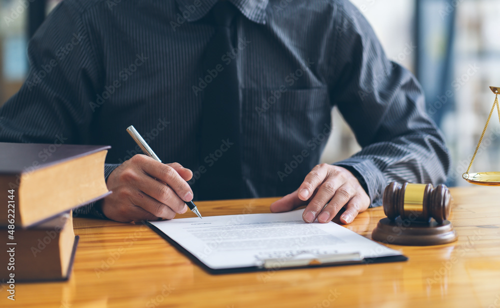 Business and lawyers discussing contract papers with brass scale on desk in office. Law, legal services, advice, justice and law concept. Business and lawyers discussing contract papers with brass scale on desk in office. Law, legal services, advice, justice and law concept.