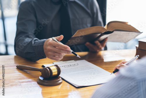 Business people negotiating a contract. Human hands working with documents at desk and signing contract, lawyer concept.