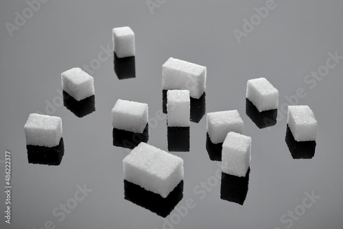 Sugar cubes on gray glossy background