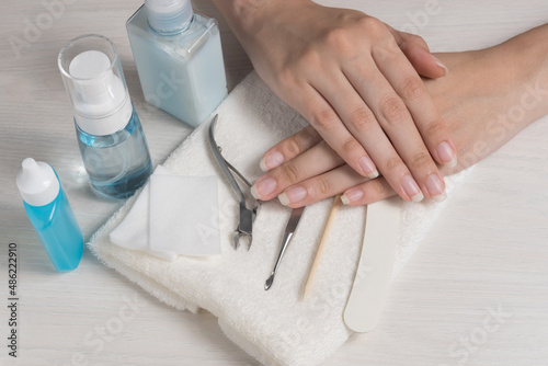 Women's hands on a towel. Manicure. Manicure tools, nail Polish. Home nail care, SPA, beauty. Long natural nails. Beauty salon.	