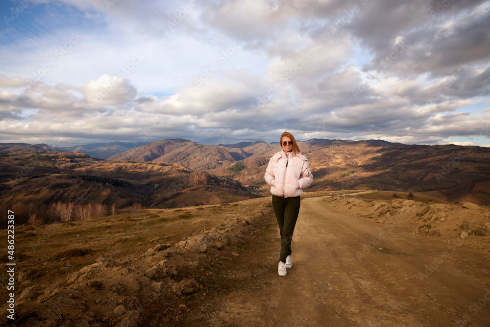 a beautiful woman tourist in autumn mountain landscape a beautiful woman tourist in autumn mountain landscape