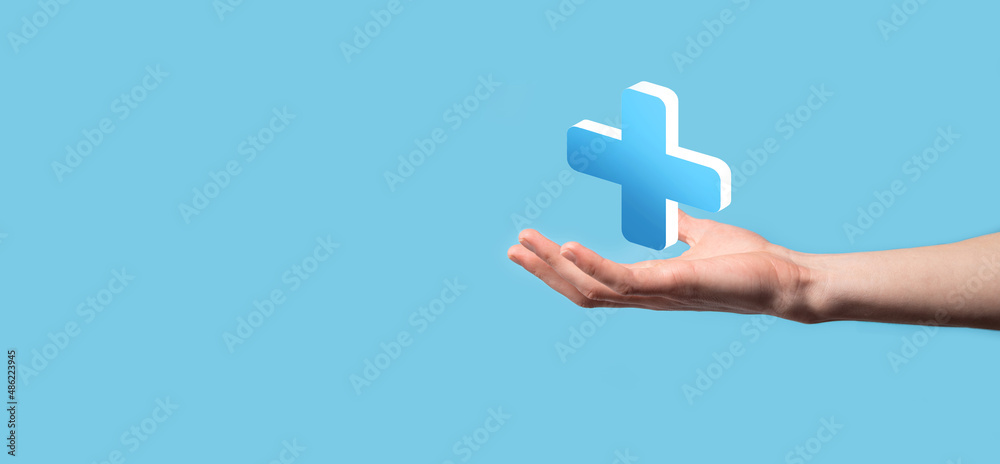 Businessman hold 3D plus icon, man hold in hand offer positive thing such as profit, benefits, development, CSR represented by plus sign.The hand shows the plus sign Businessman hold 3D plus icon, man hold in hand offer positive thing such as profit, benefits, development, CSR represented by plus sign.The hand shows the plus sign