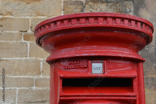 view of a tradtional old british red post box on a street in an english city photo