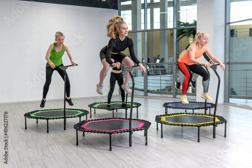 Trampoline for fitness girls are engaged in professional sports, the concept of a healthy lifestyle jumping trampoline woman fitness gym healthy, for workout active for cardio and fun athlete, young