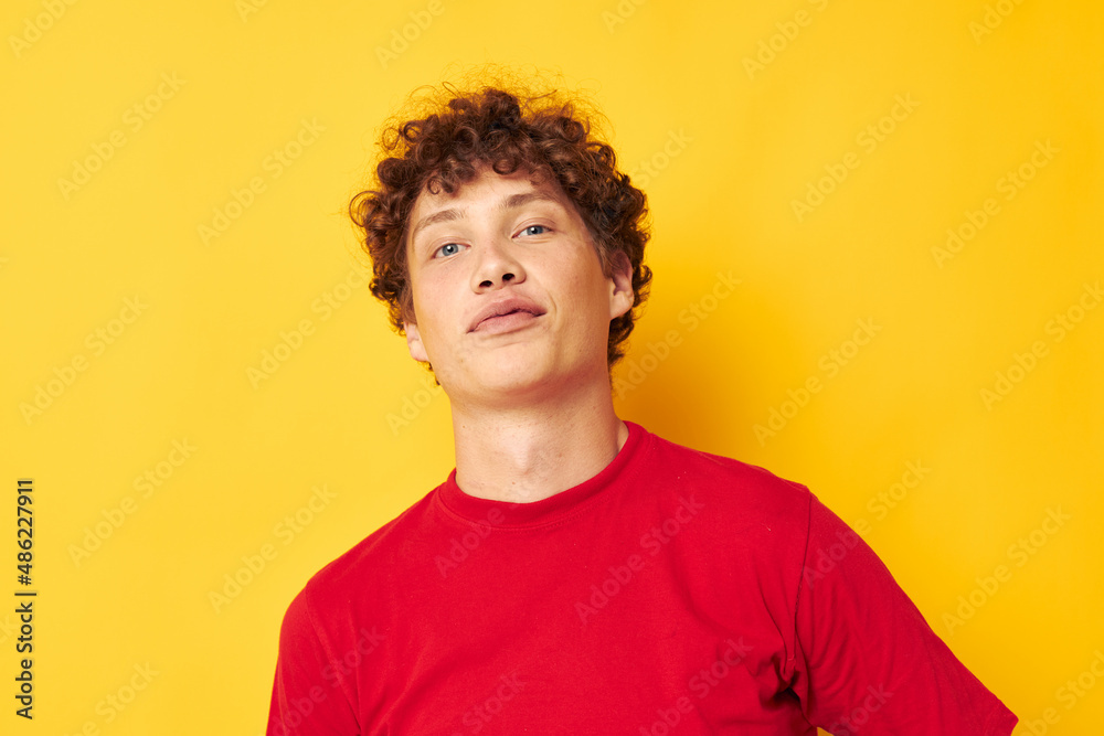 portrait of a young curly man red t shirt fun posing casual wear isolated background unaltered portrait of a young curly man red t shirt fun posing casual wear isolated background unaltered