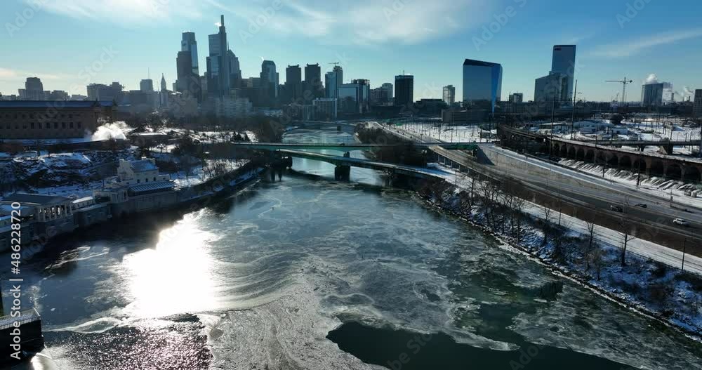 Frozen river in American city winter. Cold aerial in bright sunlight. Frozen river in American city winter. Cold aerial in bright sunlight.