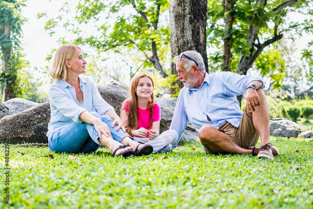 Fototapeta premium Happy family parent and child relax in weekend holiday lifestyle park outdoor nature background.