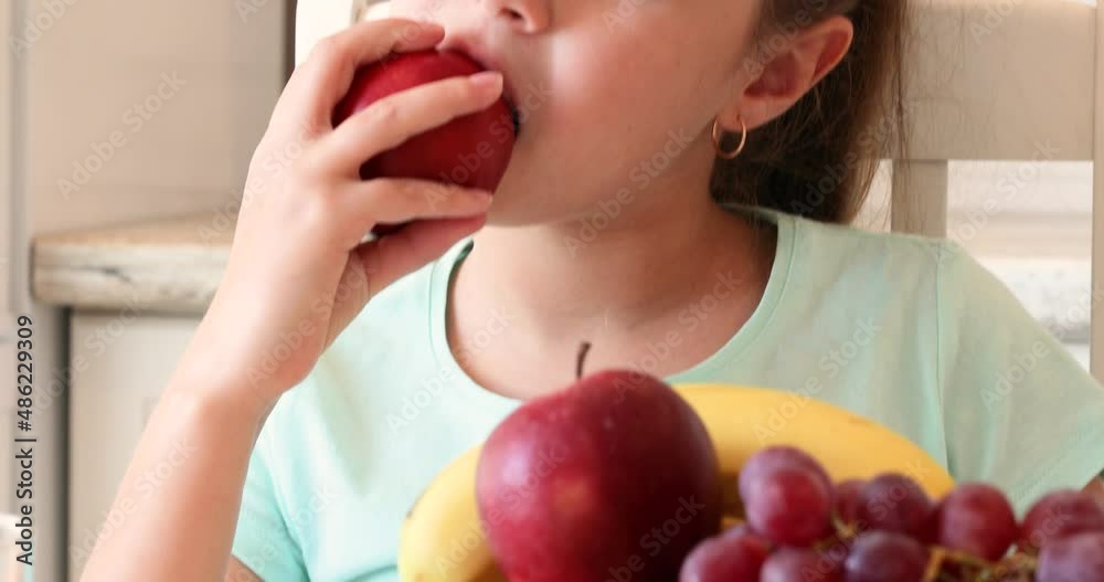 the child eats fruits with pleasure. The girl eats healthy food. the concept of children's health the child eats fruits with pleasure. The girl eats healthy food. the concept of children's health