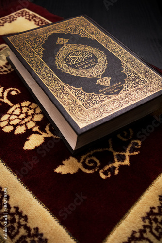 close up portrait  holy quran on a prayer matt for background