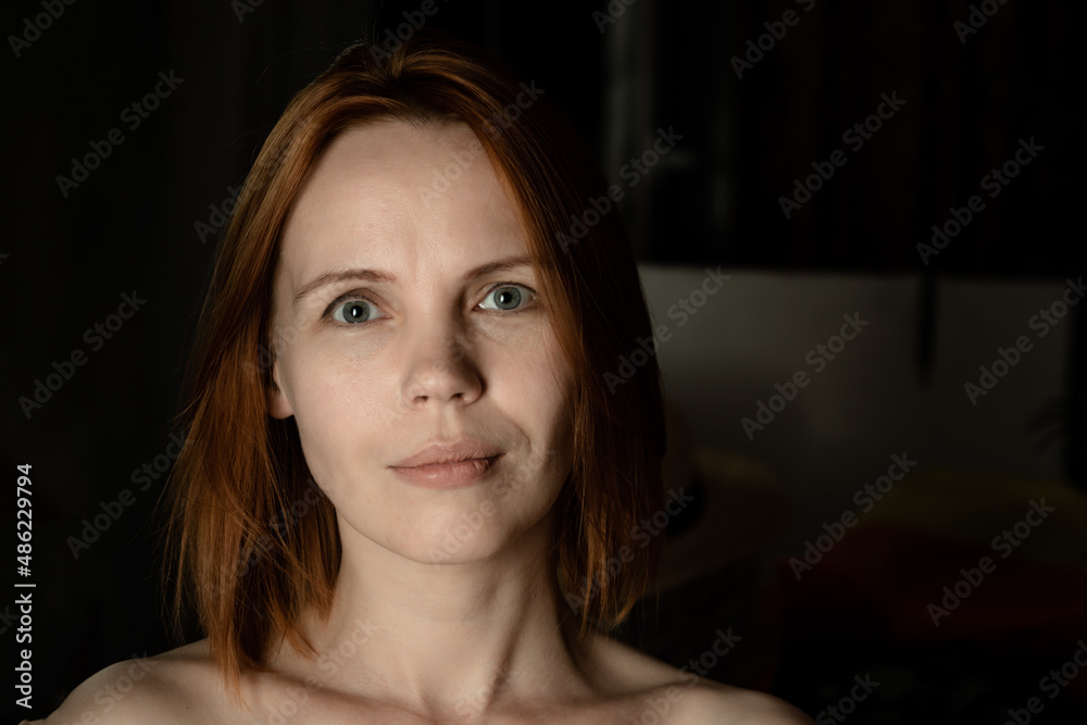 Portrait of 40 year old adult woman without makeup on black background. Portrait of 40 year old adult woman without makeup on black background.
