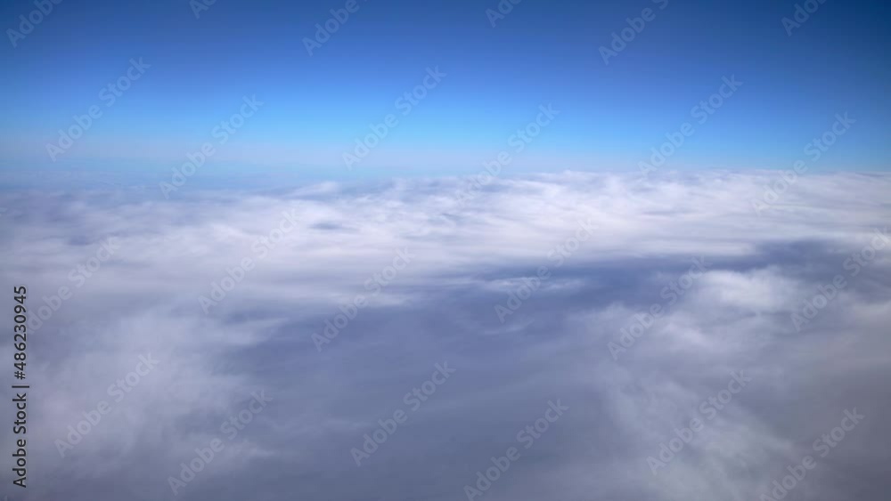 Wonderful view of cloudscape with clear blue sky from above. Beautiful panorama above white clouds as seen through window of an aircraft. A view from airplane. Wonderful view of cloudscape with clear blue sky from above. Beautiful panorama above white clouds as seen through window of an aircraft. A view from airplane.
