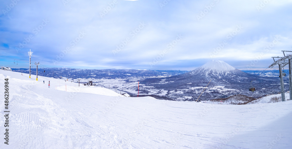 Slope with snowy volcano in a ski resort (Niseko, Hokkaido, Japan)