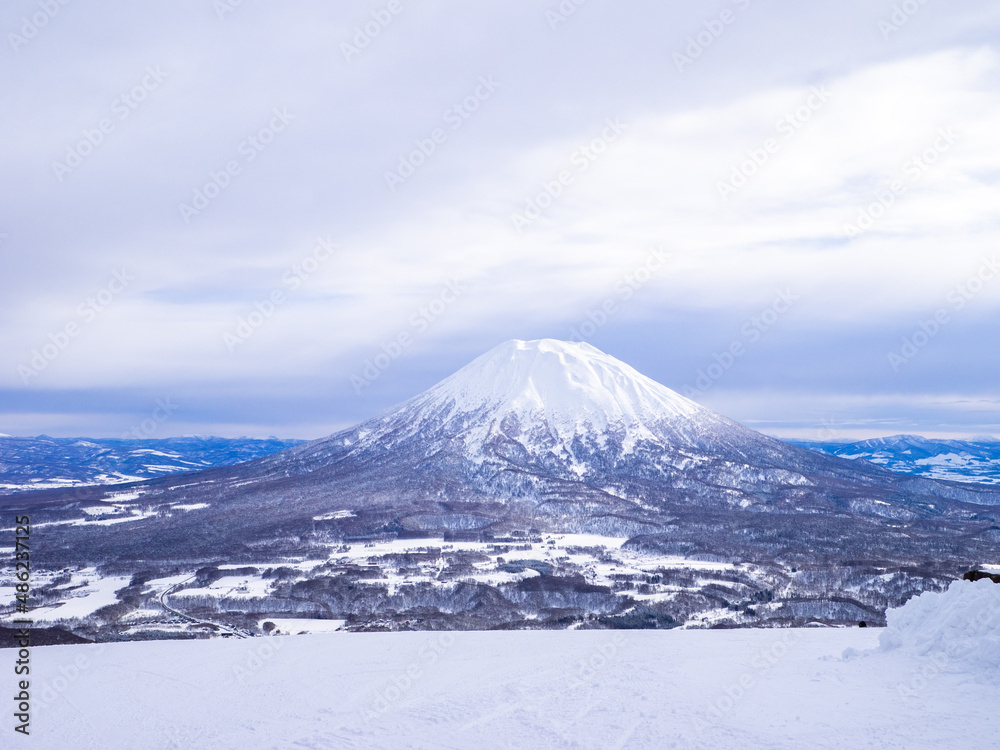 Snowy volcano and town viewed from a ski resort (Niseko, Hokkaido, Japan) Snowy volcano and town viewed from a ski resort (Niseko, Hokkaido, Japan)