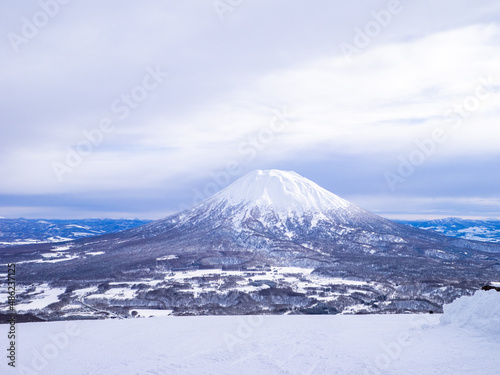 Snowy volcano and town viewed from a ski resort (Niseko, Hokkaido, Japan)