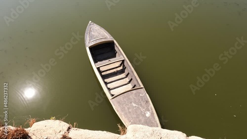 Vintage egiptian boat in green water photo