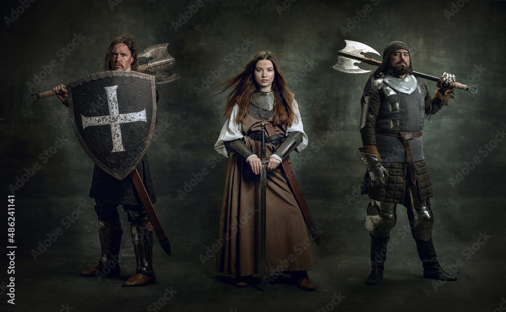 Creative art collage with brutal serious medieval warriors or knights with wounded faces holding shield, sword isolated over dark vintage background.