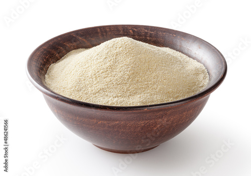 Semolina flour in ceremic bowl isolated on white background with clipping path photo