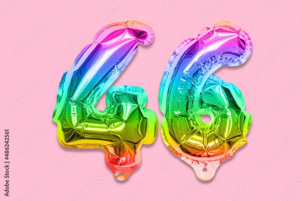 Rainbow foil balloon number, digit forty six on a pink background. Birthday greeting card with inscription 46. Anniversary concept. Top view. Numerical digit. Celebration event, template.