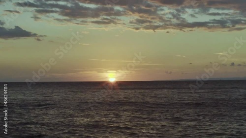 At sunset, the sun sets behind the sea.Winter landscape.Slow motion video. photo