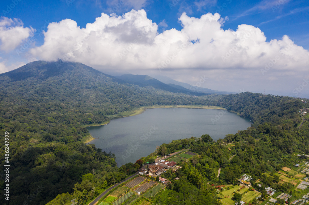 Aerial view of the lake Tamblingan in the Bali Highlands in Indonesia on a sunny day in Southeast Asia
