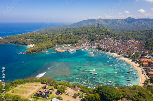 Dramatic aerial view of the Padang Bai village and harbor in east Bali in Indonesia. Silayukti temple in the foreground is one of the holiest Balinese Hindu temple in the area