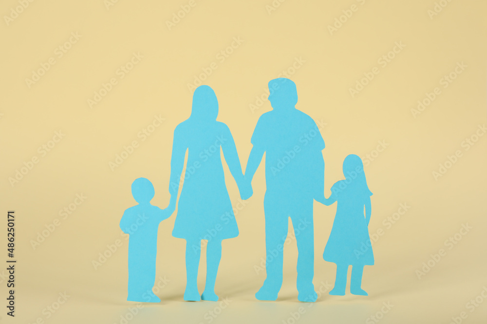 Paper family figure on beige background. Child adoption concept Paper family figure on beige background. Child adoption concept
