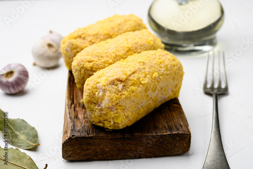 Breaded chicken cutlet, on white stone table background