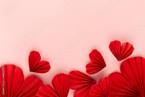 Passion love Valentine day background with red paper hearts of asian fans in modern fashion style fly on cute soft light pastel pink backdrop  footer border  copy space  top view.