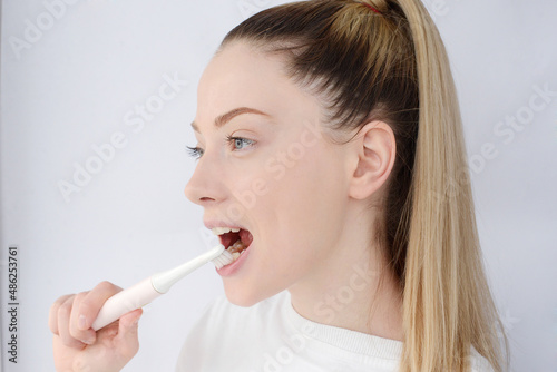 pretty woman brushing her teeth