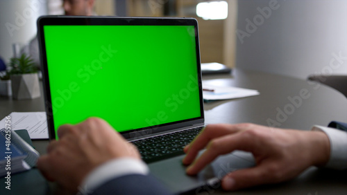 Business man using touchpad laptop green screen on corporate team conference.