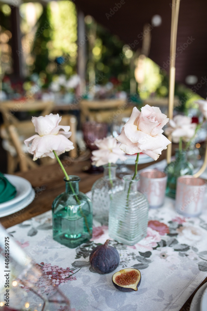 banquet table is decorated with plates, cutlery, glasses, candles and flower arrangements banquet table is decorated with plates, cutlery, glasses, candles and flower arrangements
