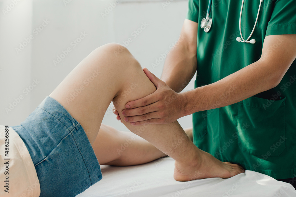 Consultation therapist with the treatment of treating injured knee of the patient with his therapist in clinic, sport physical therapy concept, Consultation therapist with the treatment of treating injured knee of the patient with his therapist in clinic, sport physical therapy concept,
