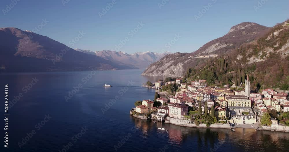 Italian lake village on a clear day aerial view with a boat on the background. Italian lake village on a clear day aerial view with a boat on the background.