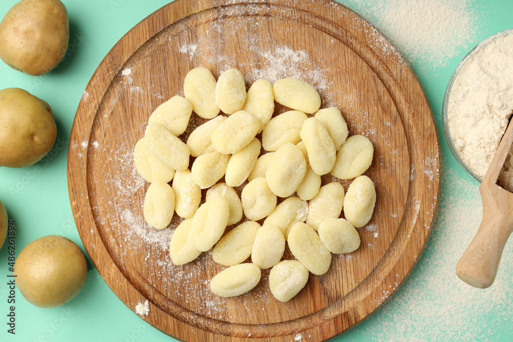 Concept of cooking with raw potato gnocchi, top view Concept of cooking with raw potato gnocchi, top view