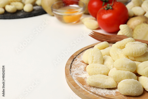 Concept of cooking with raw potato gnocchi, space for text