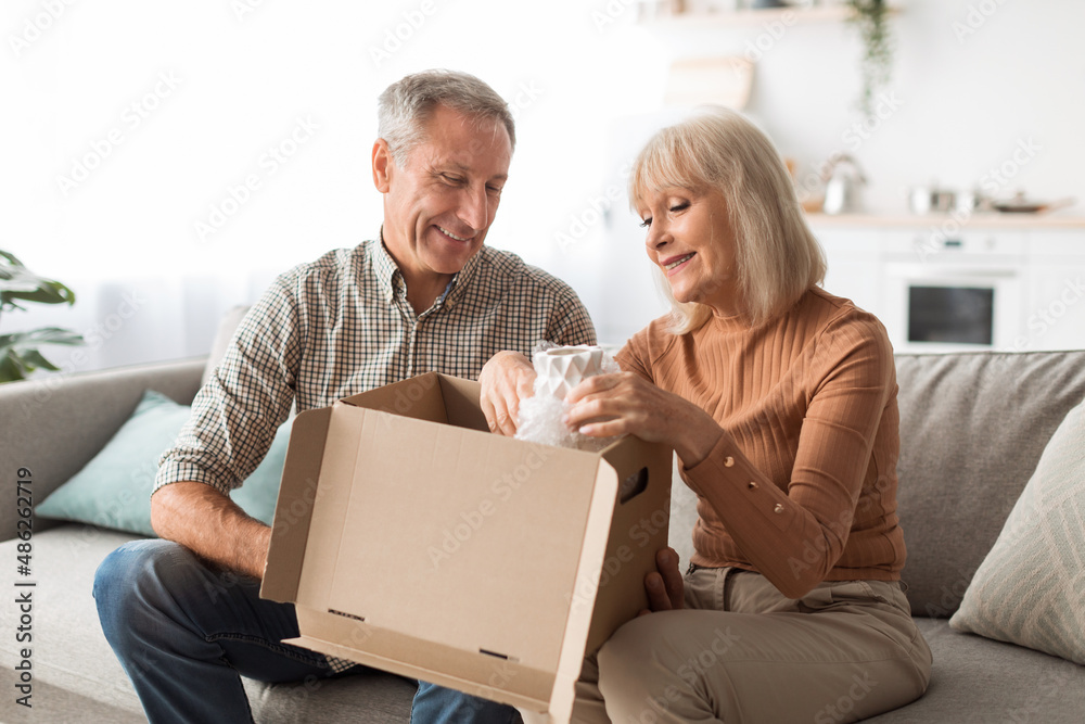 Older Couple Unpacking Box With Vase After Shopping At Home Older Couple Unpacking Box With Vase After Shopping At Home