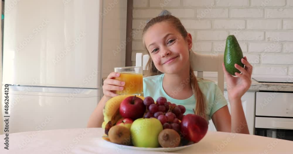 the child eats fruits with pleasure. The girl eats healthy food. the concept of children's health the child eats fruits with pleasure. The girl eats healthy food. the concept of children's health