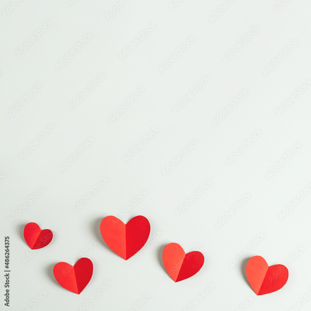 Composition with red paper hearts. Square background with copy space for Valentine's Day.