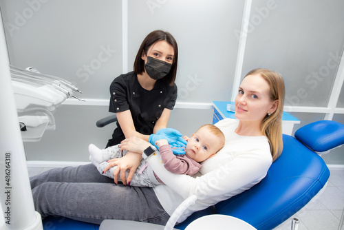 mom and baby at the reception at the pediatric dentist. First visit to the dentist. Diagnosis and treatment of milk teeth in children and infants