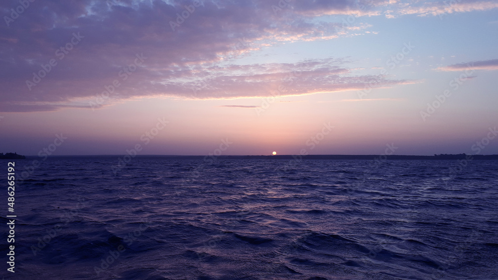 Fototapeta premium Beautiful landscape on sunrise. Seascape. View on beautiful nature early in the morning. Zen. Trendy Toned in Color of the year 2022, Very Peri.