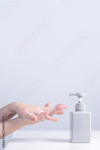 Washing hands with liquid soap for personal hygiene virus protection.