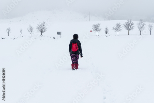 Female hiker walking in the snow