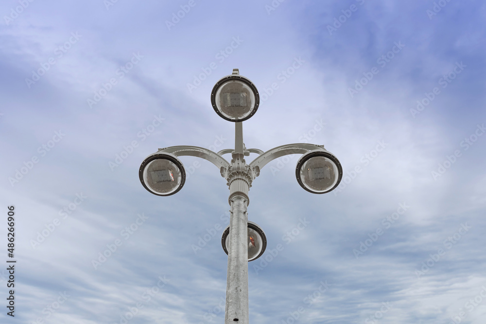 Street light against the blue sky with clouds