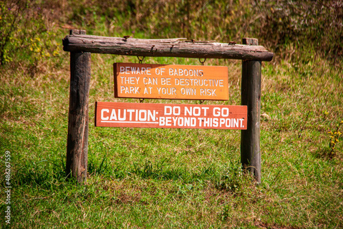 View of a sign "Beware of baboons, they can be destructive, do not go beyond this point" at the entrance of the Lake Nakuru National Park, Kenya