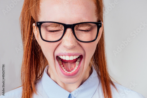 redhaired ginger student woman with open mouth and bad teeth