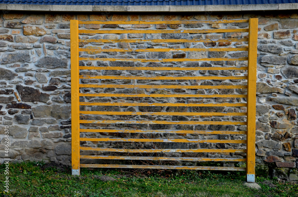 trellises for climbing plants standing alone on the lawn near the stone