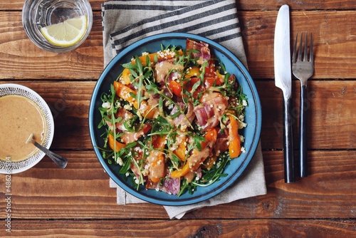 Roasted pepper salad with bacon, quinoa and wild rocket