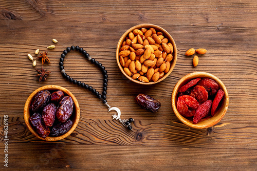 Dates fruits and islamic rosary with star and crescent. Ramadan Kareem concept